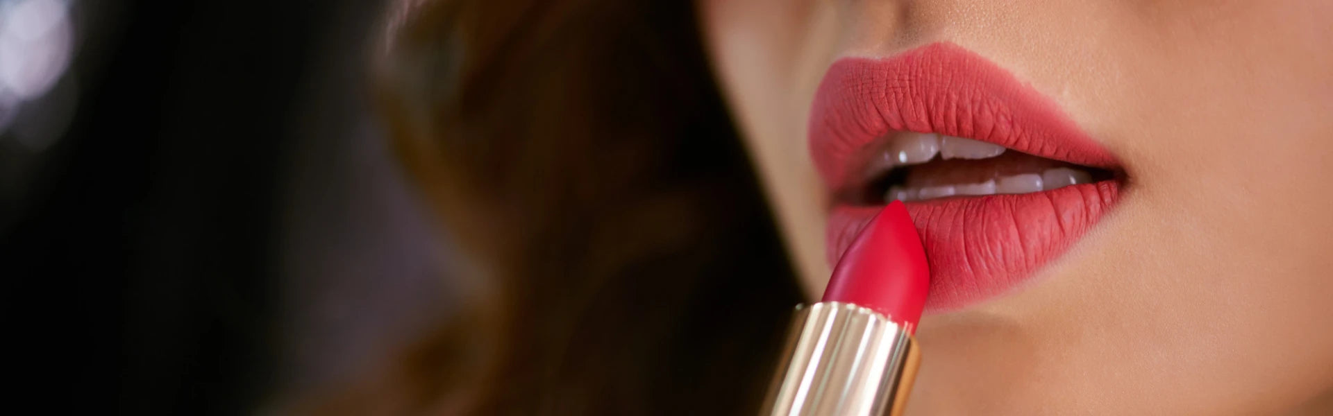 woman applying red lipstick
