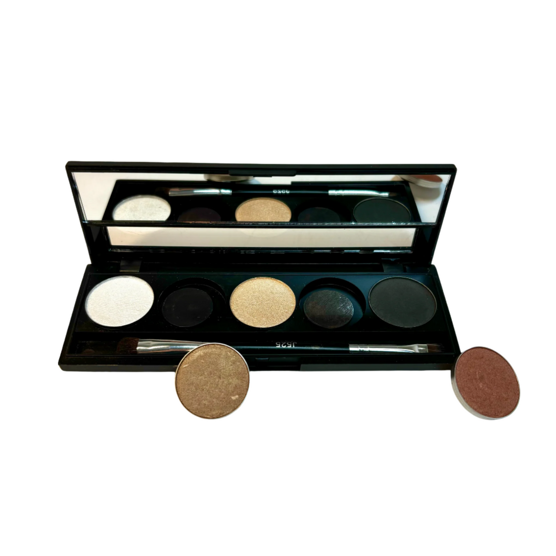 5 pan eyeshadow palette with various eyeshadows scattered about